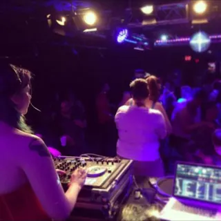 DJ Selina Style at the decks, facing the dance floor