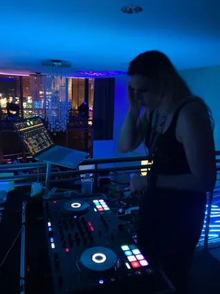 DJ Selina Style in a balcony DJ booth